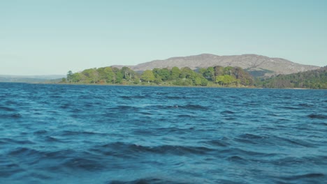Island-covered-in-lush-green-Spring-vegetation-rough-lake-Beezies-Island,-Lough-Gill