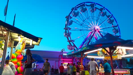 Hell-Erleuchtetes-Karnevals-Riesenrad-An-Einem-Sommerabend