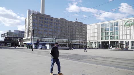 Man-with-Breathing-Mask-Walks-Across-Empty-Square-in-Times-of-Corona