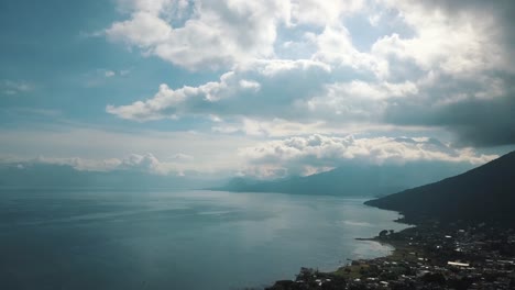 Drone-aerial-of-beautiful-lake-Atitlan,-volcanoes,-Guatemala,-Central-America