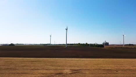 Wind-Turbines-in-Flat,-Midwest-Landscape-in-America---Aerial-Establishing-Approaching-View