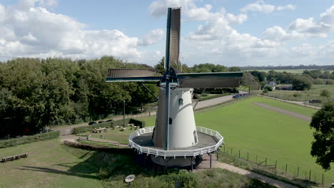 Static-shot-of-traditional-windmill-with-blades-rotating-in-the-wind