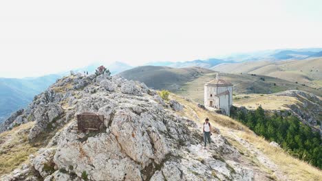 Tourist-woman-walks-at-Rocca-Calascio-medieval-fortress,-Italy