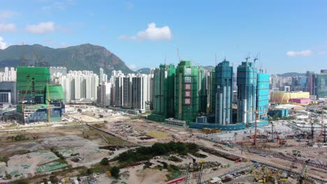 Hong-Kong-downtown-Kowloon-urban-area,-Low-angle-aerial-view-with-traffic-and-city-skyscrapers