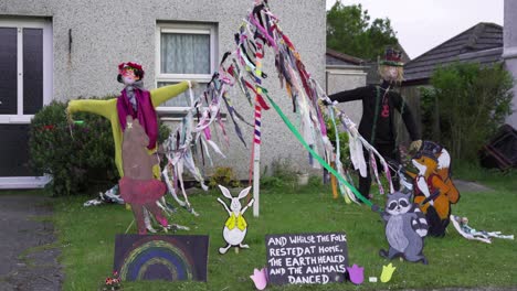 Halloween-Themed-Outdoor-Display-With-Colorful-Dressed-Scarecrows,-Hanging-Paper-Crafts-And-Zoo-Animals-Standees-In-The-Garden-Amid-The-Covid-19-Pandemic---Medium-Shot