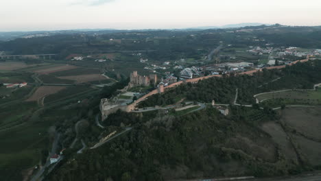 Old-Obidos-Castle-overlooking-the-green-lands-of-Leiria,-Portugal---Aerial