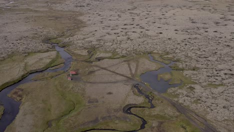 Vast-open-landscape-of-Iceland-with-small-remote-hut-in-middle-of-nowhere
