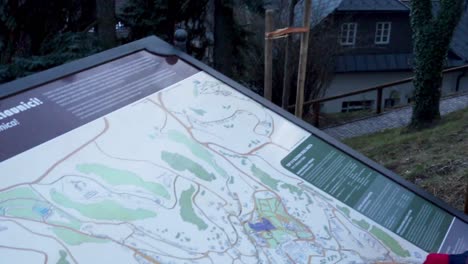 Family-is-discovering-information-board-at-the-city-of-Banska-Stiavnica,-Slovakia