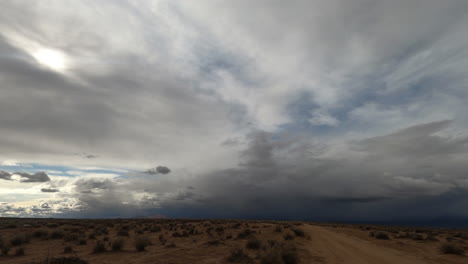 In-the-flat-topography-of-the-Mojave-Desert-basin,-storm-clouds-gather-overhead---time-lapse
