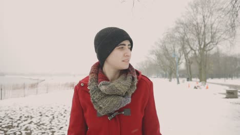 Woman-Enjoys-Walking-Through-The-Snow-On-A-Cold-Winter-Day---Handheld-Medium-Shot