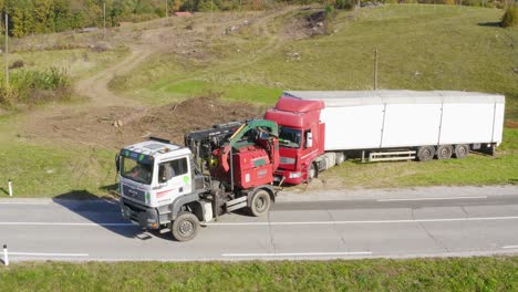 Aerial-view-at-towing-vehicle-helping-heavily-loaded-truck
