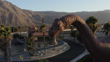 Aerial-view-of-the-Brontosaurus-head,-one-of-the-Cabazon-Dinosaurs,-World's-Biggest-Dinosaurs,-California