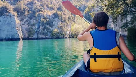 View-of-young-man-Kayaking-and-exploring-lake-at-gorges-du-verdon-in-france