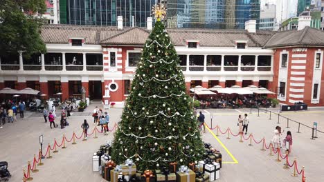 Time-lapse-of-People-viewing-a-Large-Christmas-tree-in-Hong-Kong-Former-Central-Police-Station-Compound-with-people-passing-by