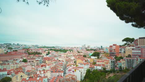Lisbon-hill-viewpoint-through-fences-to-downtown-ancient-city-roofs-at-cloudy-day