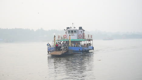 A-Small-Ferry-boat-sailing-towards-shore-or-dock-with-full-of-passengers-in-it,-ready-to-departure-on-port-in-Mumbai-city-video-background-in-Prores-422-HQ