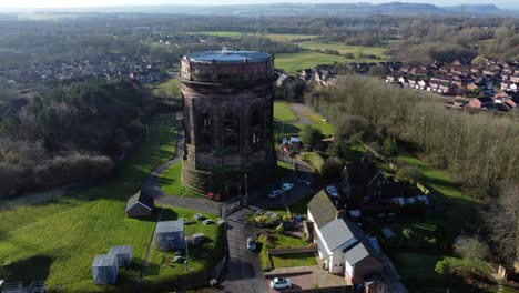 Aerial-view-National-trust-Norton-water-tower-landmark-Runcorn-British-rural-countryside-rising-left