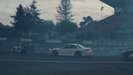 Drifting-Sports-Cars-on-Circuit-Track-Passing-Bend-on-High-Speed,-Tracking-Shot
