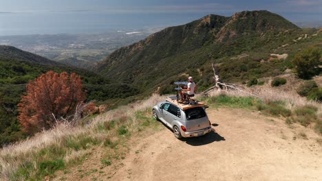 Aerial-view-of-a-solo-drummer-on-top-of-his-car-over-looking-Santa-Barbra-California