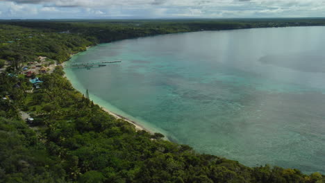 Aerial-view-around-shallow-water-and-a-beach,-on-the-Lifou-Island---circling,-drone-shot