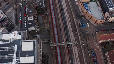 Pan-up-follow-drone-shot-of-Train-pulling-into-London-Waterloo-station