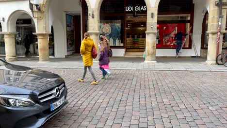 Slow-motion-shot-of-family-walking-on-road-wearing-face-mask-for-protection-against-corona-virus