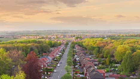 Aerial-view-of-typical-British-rural-countryside-street-with-houses-in-golden-hour