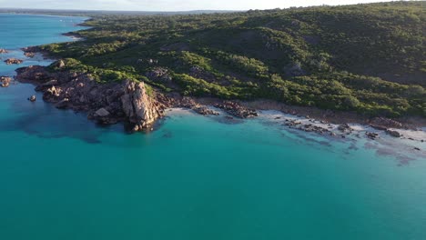 Aerial-view,-Leeuwin-Naturaliste-National-Park-picturesque-coastline-sandy-Castle-Rock-beach-rock-formations-and-green-rainforest-on-sunny-day,-Australia,-drone-shot