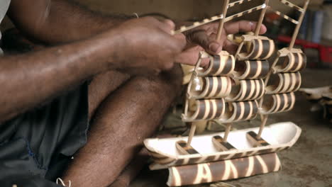 A-tribal-male-in-the-Dang-district-is-busy-building-replica-ships-from-Bamboo