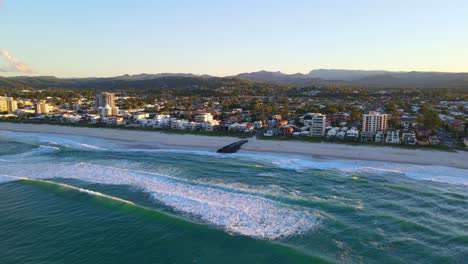 Waves-On-Rocky-Groyne-At-Sandy-Coastline-Of-Palm-Beach-In-Gold-Coast-City,-Australia