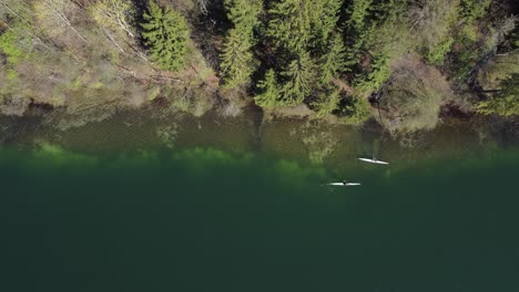 AERIAL-Two-Kayaks-in-a-Blue-Lake-in-Vilnius,-Lithuania
