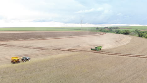 Agricultural-tractor-harvesting-soybeans-in-the-field