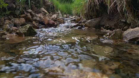 Real-time-of-wild-mountain-river-water-stream-running-through-rocks