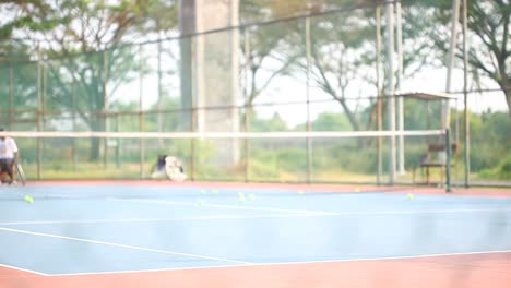 Yogyakarta,-Indonesia---May-2,-2021-:-Veiled-asian-woman-in-wheelchair-playing-tennis-on-court