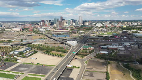 Aerial-View-of-Denver,-Colorado-USA,-Sunny-Cityscape,-Central-Downtown-Buildings-and-Freeway-Traffic,-Drone-Shot