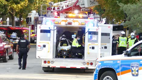 Crime-investigator-walks-behind-the-emergency-bus-back-view