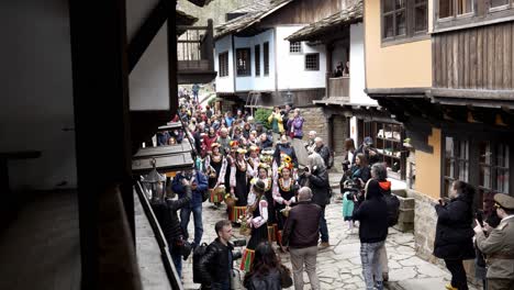 Singing-slow-mo-procession-of-Pretty-Bulgarian-girls-in-colourful-traditional-dress-being-filmed