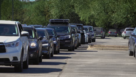 Long-lines-of-people-waiting-in-cars-at-mass-vaccination-site,-food-pantry-line-during-pandemic,-4K