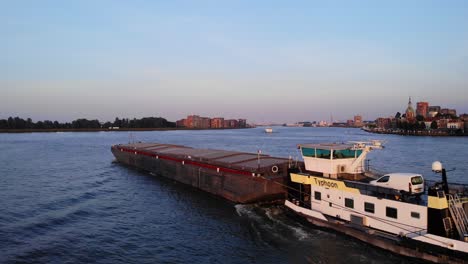 Aerial-Follow-Shot-Of-Typhoon-Pusher-Boat-Travelling-Along-On-Oude-Maas-In-Dordrecht