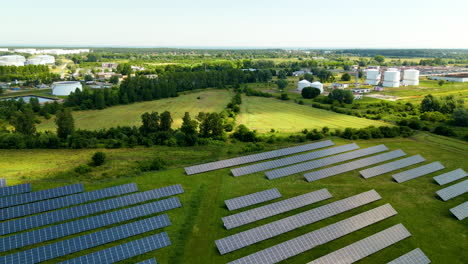 Industrial-solar-panel-farm-in-countryside-of-Poland-under-shadow-of-cloud,-aerial