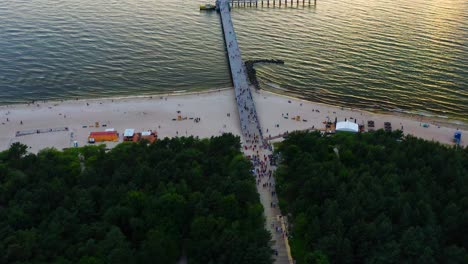 Aerial-View-Of-Sea-Bridge-In-Palanga,-Lithuania-At-Sunset---drone-shot