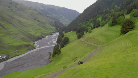 Rotating-drone-shot-of-vehicle-driving-on-the-Abano-Pass,-the-road-to-Tusheti-Georgia
