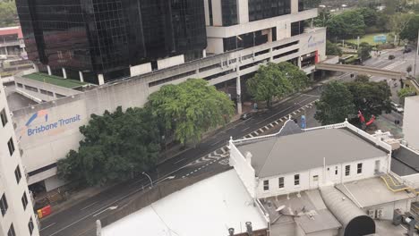 4K-UHD-Time-lapse-of-car-traffic-and-people-crossing-street,-commuter-trains-in-background,-Brisbane-Transit-Centre