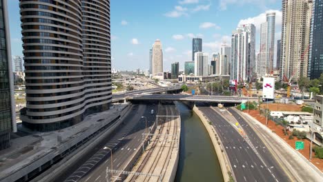 Aerial-view-over-the-Ayalon-River,-in-middle-of-the-empty-city-of-Tel-Aviv,-Israel---tilt,-drone-shot