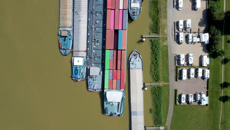 Top-down-aerial-of-sea-containers-on-board-of-docked-cargo-ship---wide