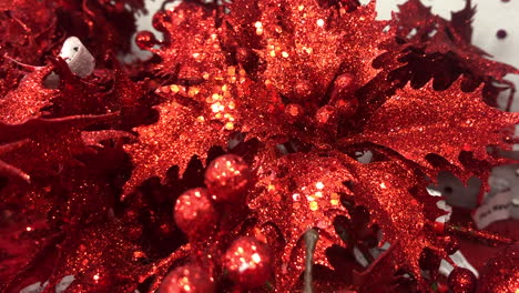 Christmas-holly-and-berries-decorations-painted-red-with-glitter-sparkles-for-sale-in-a-store