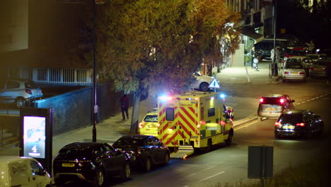 Panning-shot-following-an-ambulance-with-flashing-lights-in-London,-England