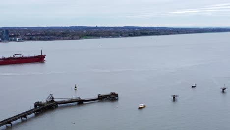 Silver-Rotterdam-oil-petrochemical-shipping-tanker-departing-Tranmere-terminal-Liverpool-aerial-view-pull-back