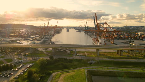 Aerial-Pullback---Container-Terminal-at-Harbour-of-Gdynia-Port-on-Sunset,-Baltic-Coast,-Poland