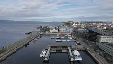 Aerial-View-Of-Harbour-In-Trondheim,-Norway---drone-pullback